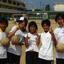 Junior high school students take a break from shotput practice. Photo by JL, (c) ASC