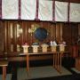 Interior of a Shinto shrine with sacred mirror and offerings of food and sake at the altar. Photo by JL, (c) ASC